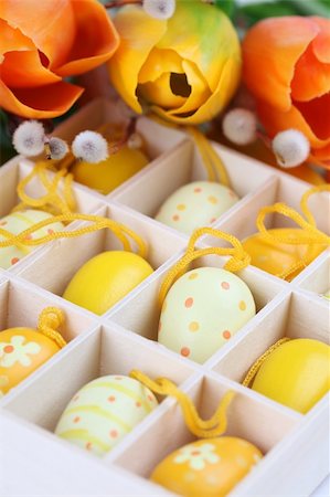 simsearch:400-04291976,k - Yellow Easter eggs in a box and colorful tulips. Shallow dof Photographie de stock - Aubaine LD & Abonnement, Code: 400-04321851