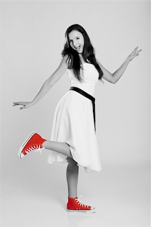 Beautiful young woman wearing a white dress with a pair of red sneakers Stock Photo - Budget Royalty-Free & Subscription, Code: 400-04322102