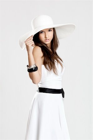 simsearch:400-04307166,k - Beautiful and fashion young woman posing and wearing a wonderful white dress with a white hat Stock Photo - Budget Royalty-Free & Subscription, Code: 400-04322113