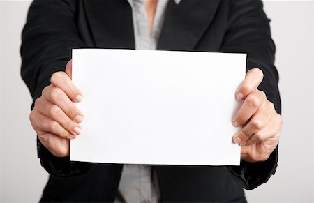 Woman holding a blank paper sheet with both hands Stock Photo - Budget Royalty-Free & Subscription, Code: 400-04322227