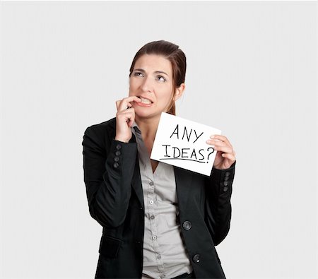 simsearch:400-04648812,k - Business woman biting the nails and holding a card board with the text message "Hire me" Stock Photo - Budget Royalty-Free & Subscription, Code: 400-04322230
