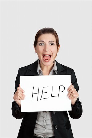 people in panic - Stressed business woman imploring for help, holding a cardboard with the message "Help" Stock Photo - Budget Royalty-Free & Subscription, Code: 400-04322233