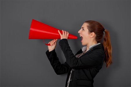 Business young woman speaking to a megaphone, over a grey background Stock Photo - Budget Royalty-Free & Subscription, Code: 400-04322259