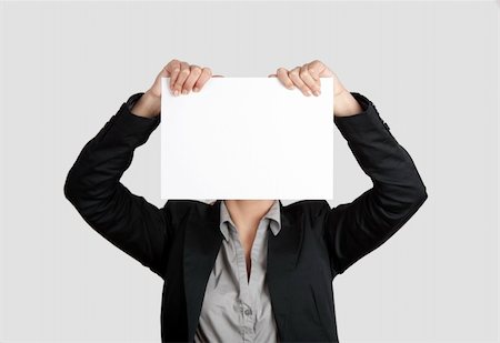 simsearch:400-04364119,k - Woman showing a blank paper sheet in front of her head Fotografie stock - Microstock e Abbonamento, Codice: 400-04322253