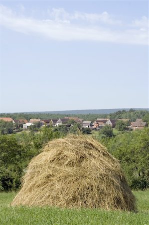 simsearch:400-06201047,k - Hay stack with village behind Stock Photo - Budget Royalty-Free & Subscription, Code: 400-04322810