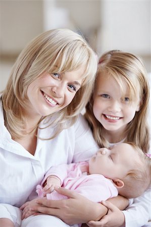 sister hugs baby - Mom holding the baby in her arms and her daughter Stock Photo - Budget Royalty-Free & Subscription, Code: 400-04323139