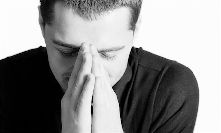 simsearch:400-04178541,k - Young man praying with eyes closed closeup isolated on white Photographie de stock - Aubaine LD & Abonnement, Code: 400-04323391