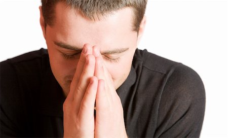 Young man praying with eyes closed closeup isolated on white Stockbilder - Microstock & Abonnement, Bildnummer: 400-04323392