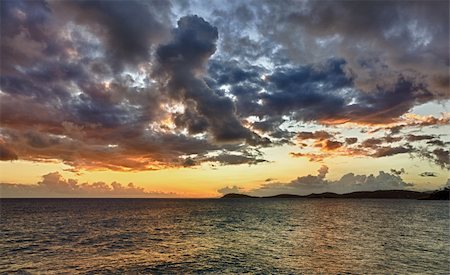 HDR impression of a sunset over the ocean with a distant island on the horizon Foto de stock - Royalty-Free Super Valor e Assinatura, Número: 400-04323467
