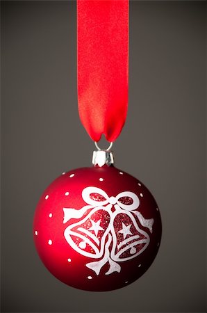 beautiful red christmas toy ball hanging on the red ribbon against dark grey background Fotografie stock - Microstock e Abbonamento, Codice: 400-04323504