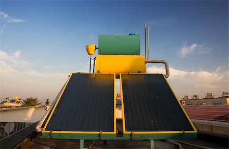 Hot water solar heating systems on rooftop Stock Photo - Budget Royalty-Free & Subscription, Code: 400-04323700