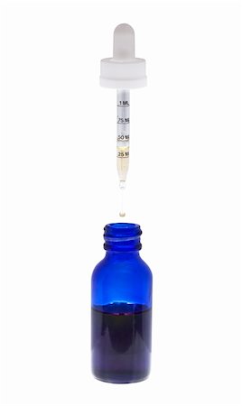 Eye dropper dripping liquid into a blue bottle. Stockbilder - Microstock & Abonnement, Bildnummer: 400-04323763