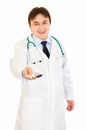 simsearch:400-07099832,k - Smiling medical doctor holding packs of pills in hand isolated on white Stock Photo - Budget Royalty-Free & Subscription, Code: 400-04334102