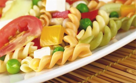 simsearch:400-04854606,k - Pasta salad with fresh vegetables (tomato, pea, bell pepper) and cheese (Selective Focus, Focus on the first pasta) Foto de stock - Royalty-Free Super Valor e Assinatura, Número: 400-04334387