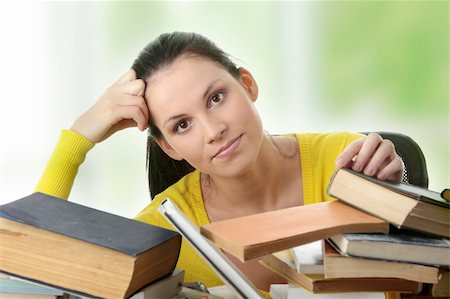 simsearch:400-05112397,k - Young woman sitting behind books Foto de stock - Super Valor sin royalties y Suscripción, Código: 400-04334594