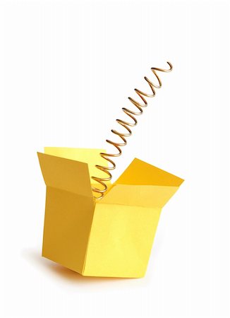 Metal spring inside open yellow paper box. Isolated on white with clipping path Foto de stock - Super Valor sin royalties y Suscripción, Código: 400-04334592