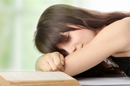 Sleeping while learning - tired teen woman sleeping on desk Stock Photo - Budget Royalty-Free & Subscription, Code: 400-04334601