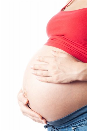 simsearch:400-04334843,k - Pregnant woman holding her belly with hands over white background Foto de stock - Royalty-Free Super Valor e Assinatura, Número: 400-04334843
