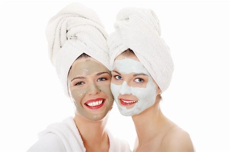 dirt in face with smile - Happy two young woman with anti-aging masks . Isolated on white background. Stock Photo - Budget Royalty-Free & Subscription, Code: 400-04334852