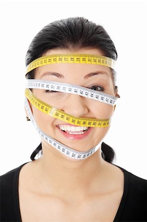 Beautiful young caucasian woman with measuring tape around her head, isolated on white. Diet concept Foto de stock - Super Valor sin royalties y Suscripción, Código: 400-04335050