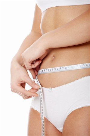 digestion female - Female measuring her body, isolated on white Foto de stock - Super Valor sin royalties y Suscripción, Código: 400-04335070