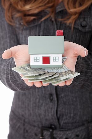 simsearch:400-04350998,k - Young businesswoman holding euros bills and house model over white - real estate loan concept Stock Photo - Budget Royalty-Free & Subscription, Code: 400-04335136