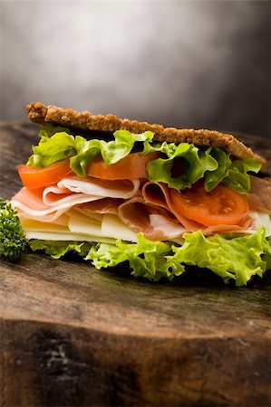 photo of delicious sandwich with smoked bacon and cheese on wooden table Stockbilder - Microstock & Abonnement, Bildnummer: 400-04335393