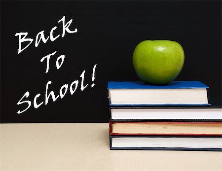 pencil and apple on teacher desk - School books with apple on desk, on black school board background Stock Photo - Budget Royalty-Free & Subscription, Code: 400-04335779