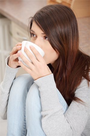 simsearch:400-04335902,k - Young beautiful woman having coffee or tea in the kitchen Stock Photo - Budget Royalty-Free & Subscription, Code: 400-04335901