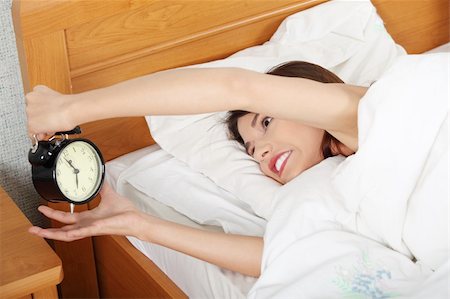 simsearch:400-04206266,k - Sleepy woman in morning trying to turn off alarm clock Stockbilder - Microstock & Abonnement, Bildnummer: 400-04335937