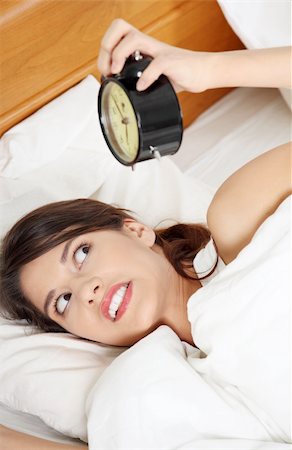 simsearch:400-04206266,k - Sleepy woman in morning trying to turn off alarm clock Stockbilder - Microstock & Abonnement, Bildnummer: 400-04335938
