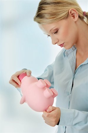 Young beautiful woman standing with piggy bank (money box). Stock Photo - Budget Royalty-Free & Subscription, Code: 400-04336224