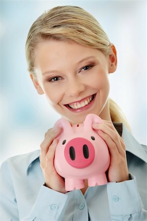 Young beautiful woman standing with piggy bank (money box). Stock Photo - Budget Royalty-Free & Subscription, Code: 400-04336225