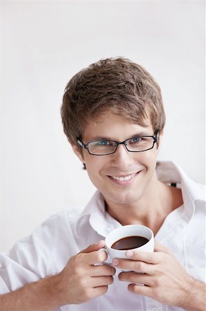 A young handsome man with a coffee Stock Photo - Budget Royalty-Free & Subscription, Code: 400-04336285