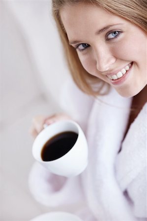 An attractive young woman holding a cup of coffee Stock Photo - Budget Royalty-Free & Subscription, Code: 400-04336460