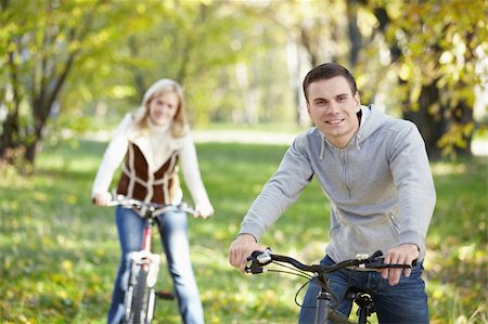 simsearch:400-04336549,k - A young man on a bicycle in the foreground Fotografie stock - Microstock e Abbonamento, Codice: 400-04336547