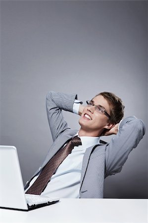simsearch:400-04336593,k - A young man in a suit rests in the workplace Stock Photo - Budget Royalty-Free & Subscription, Code: 400-04336572