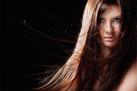 simsearch:400-06482471,k - Attractive girl with developing hair on a black background Stock Photo - Budget Royalty-Free & Subscription, Code: 400-04336650