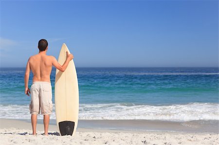 simsearch:400-05319489,k - Man wirth his surfboard on the beach Stock Photo - Budget Royalty-Free & Subscription, Code: 400-04336719