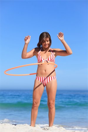 Woman playing with a hula hoop Fotografie stock - Microstock e Abbonamento, Codice: 400-04336755