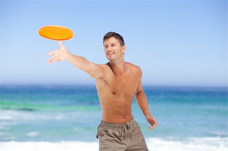 play frisbee in the beach - Man playing frisbee Stock Photo - Budget Royalty-Free & Subscription, Code: 400-04336810