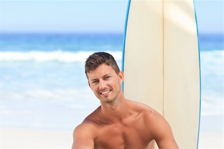 simsearch:400-05319489,k - Handsome man with his surfboard Stock Photo - Budget Royalty-Free & Subscription, Code: 400-04336834