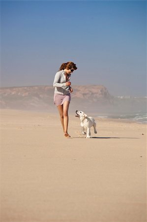 simsearch:400-05259756,k - Young woman running and playing with her cute labrador retriever puppy Photographie de stock - Aubaine LD & Abonnement, Code: 400-04337012