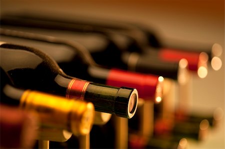 Wine bottles in rack shot with very limited depth of field Stock Photo - Budget Royalty-Free & Subscription, Code: 400-04337181