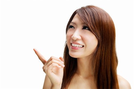 simsearch:400-06142860,k - Asian woman pointing to empty space, ready for text. Fotografie stock - Microstock e Abbonamento, Codice: 400-04337213