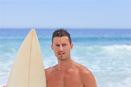 simsearch:400-05319489,k - Man posing with his surfboard Stock Photo - Budget Royalty-Free & Subscription, Code: 400-04337705