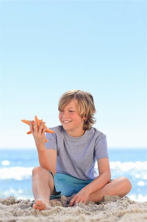elementary boys swimming - Little boy with a starfish Stock Photo - Budget Royalty-Free & Subscription, Code: 400-04337714