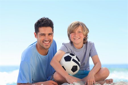 father and son play football - Father and his son with a ball Stock Photo - Budget Royalty-Free & Subscription, Code: 400-04337715