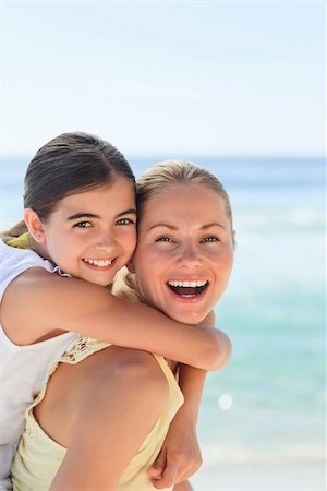 piggyback daughter at beach - Mother having daughter a piggyback at the beach Stock Photo - Budget Royalty-Free & Subscription, Code: 400-04337735