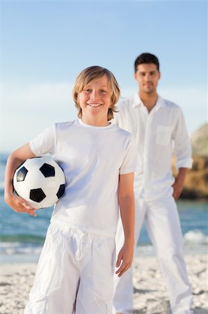 parents cheering for kid soccer - Father and his son on the beach Stock Photo - Budget Royalty-Free & Subscription, Code: 400-04338888